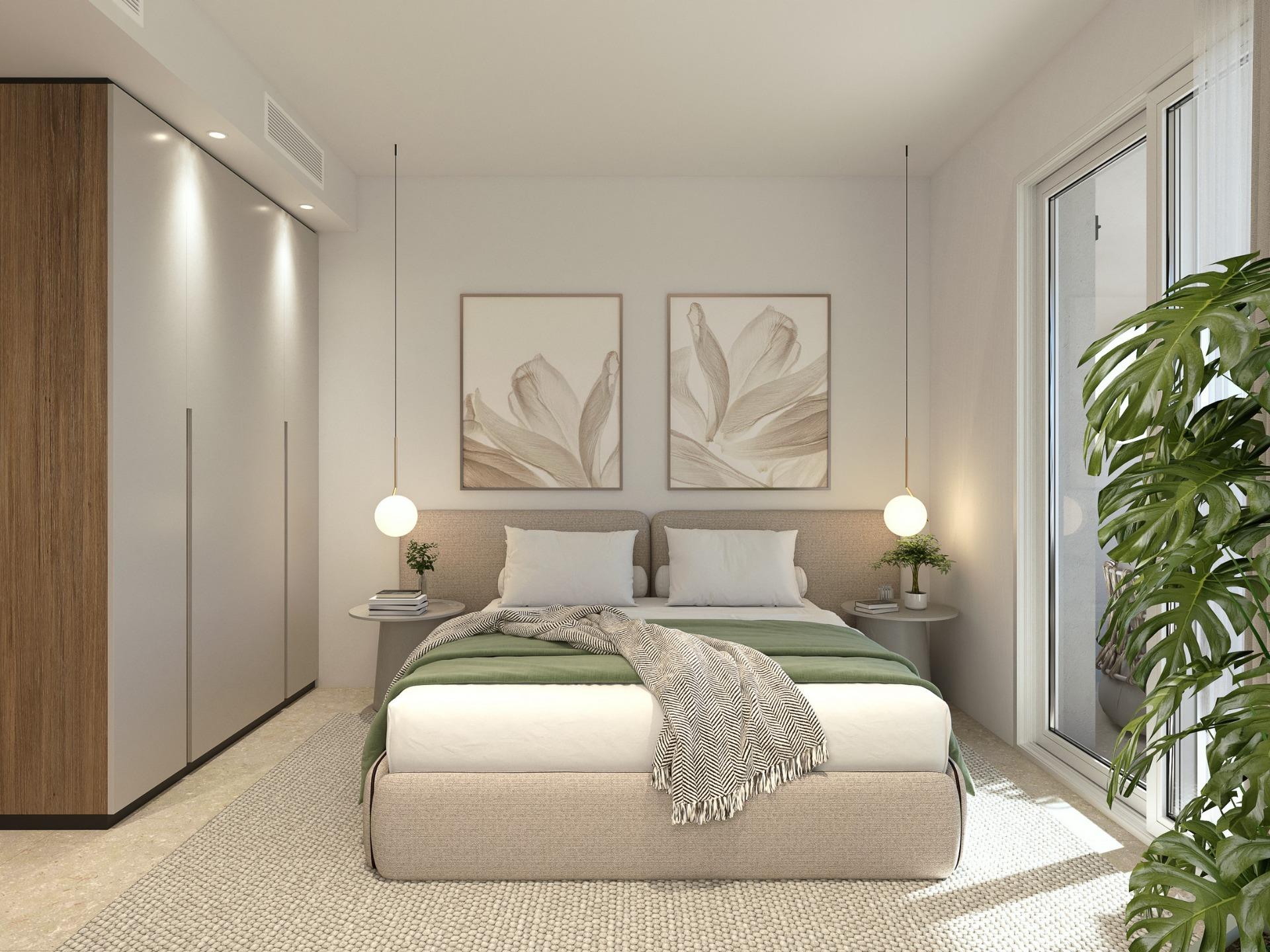 Bright, modern 2-bedroom penthouse bedroom with minimalist decor and sea-view balcony in luxury Mil Palmeras new build.