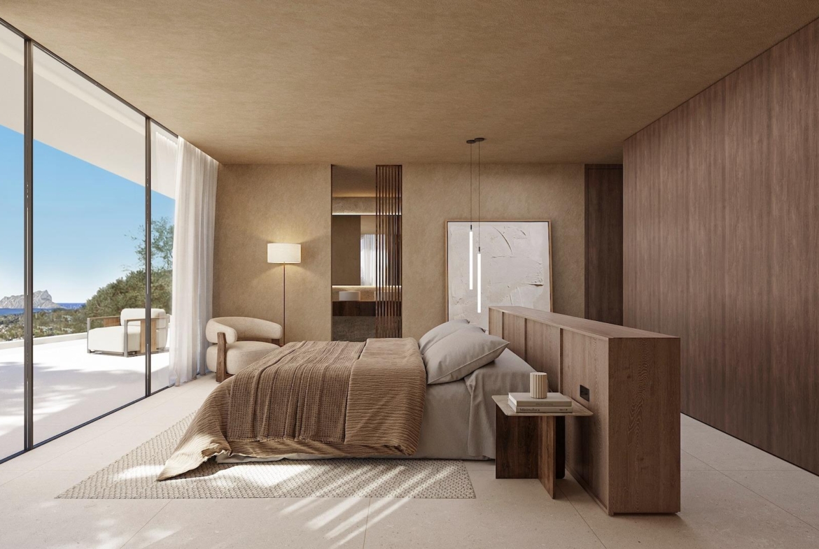 Spacious sunlit bedroom with floor-to-ceiling windows, elegant wood accents, and panoramic sea views in Benissa villa.