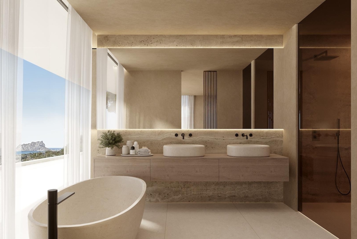 Bright, modern bathroom with freestanding tub, double sinks, sleek finishes, and panoramic sea views in Benissa luxury villa.