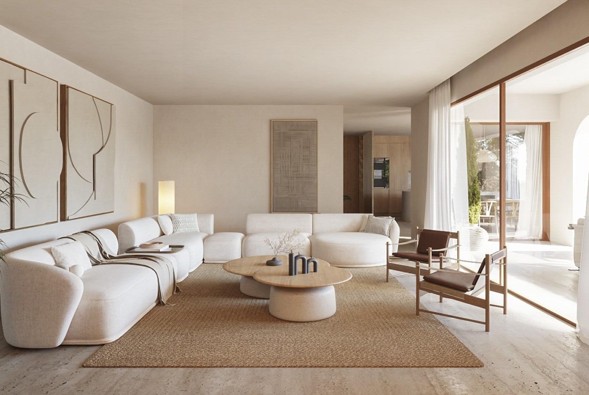 Sun-drenched, elegant living room with curved sofa and natural textures in new Ibizan-style villa in La Fustera, Benissa