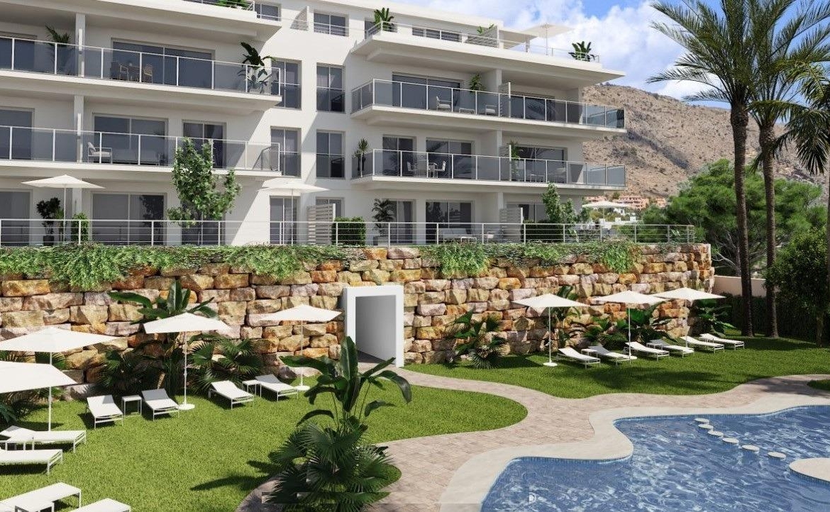 Sun-drenched communal pool and landscaped terrace of spacious 3-bedroom new build apartment in Sierra Cortina, Finestrat