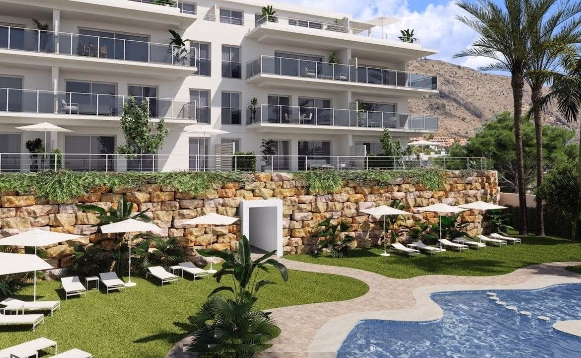 Sun-drenched communal pool and landscaped terrace of spacious 3-bedroom new build apartment in Sierra Cortina, Finestrat