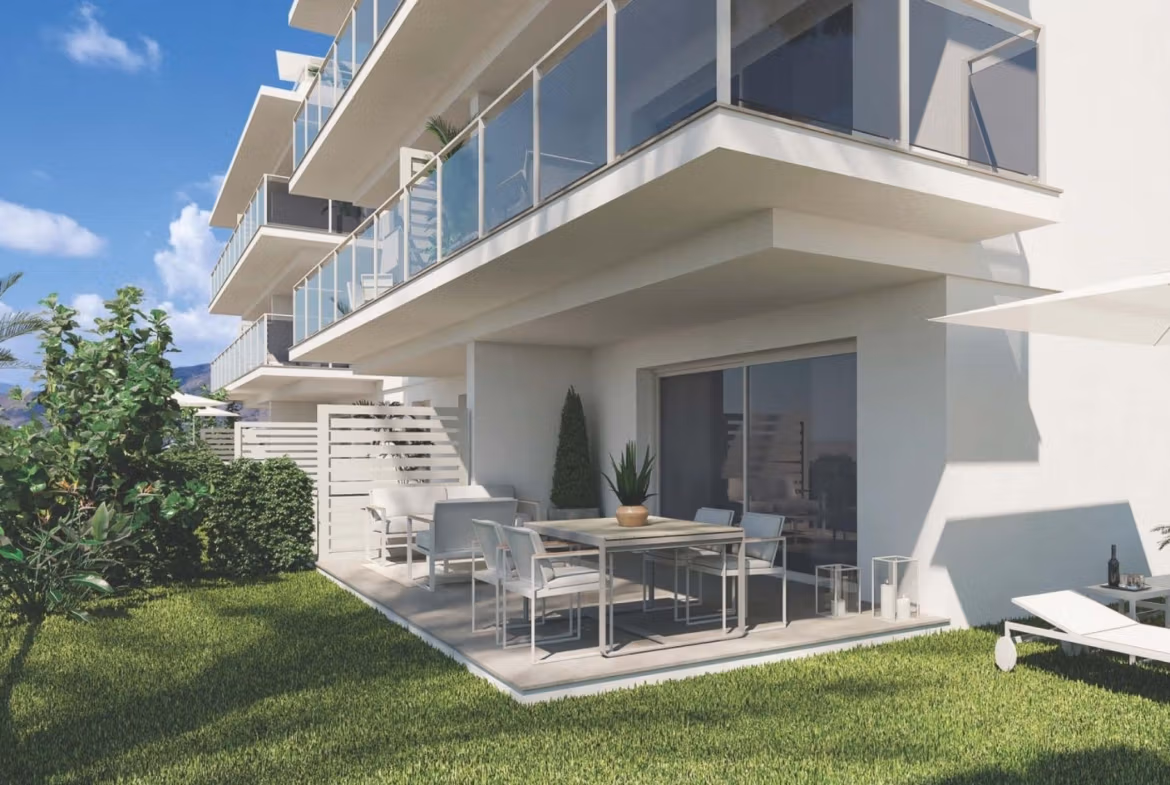 Modern spacious 3-bedroom apartment terrace and garden with sunlit lounge chairs in luxury Sierra Cortina, Finestrat development.