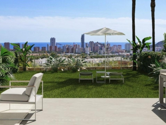 Spacious sun-drenched terrace with elegant seating, landscaped garden, and panoramic views in modern 2-bedroom Sierra Cortina apartment.