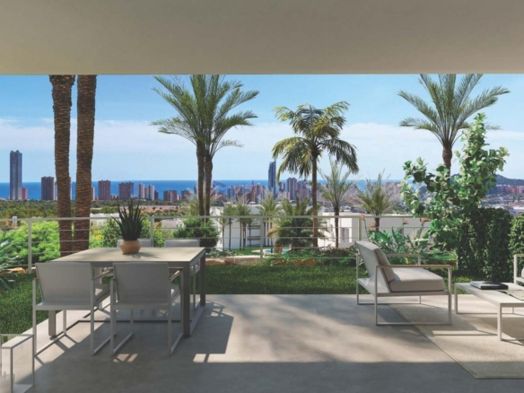 Sunlit terrace with modern outdoor seating, lush landscaping, and panoramic sea views in a spacious 3-bedroom apartment in Sierra Cortina, Finestrat.