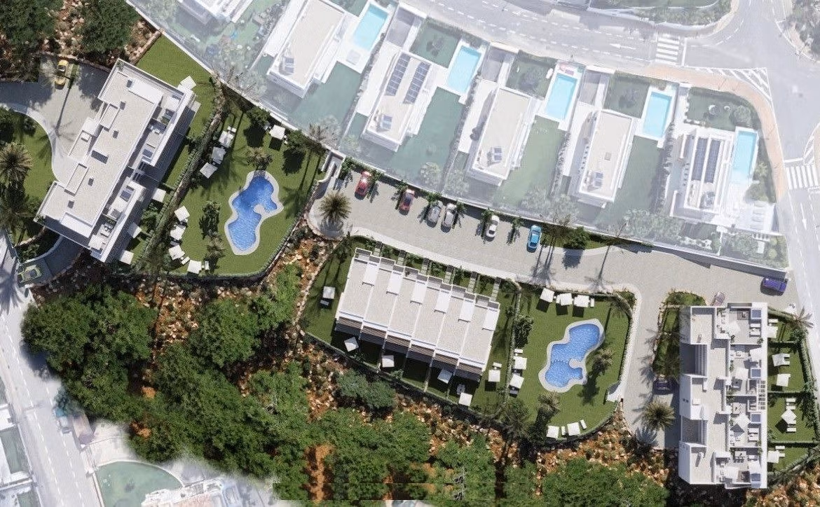 Aerial view of spacious new build 3-bedroom apartment complex in Sierra Cortina, Finestrat with landscaped gardens and blue communal pools.