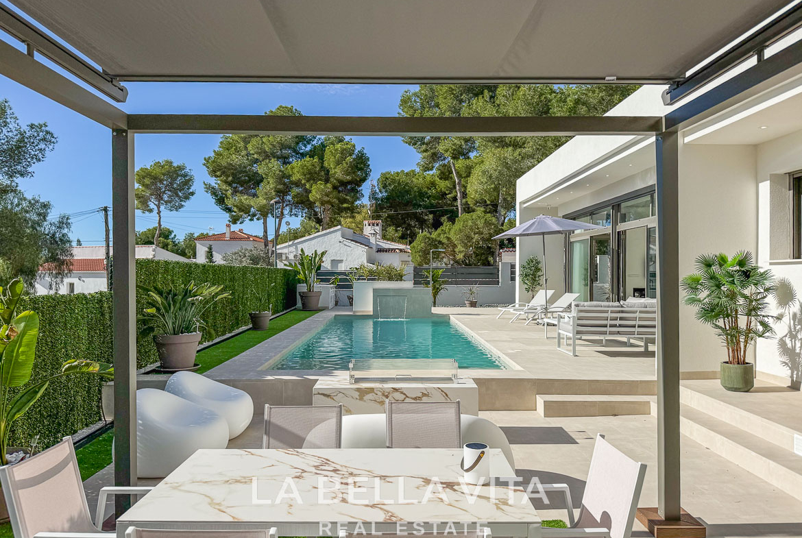 Modern 3-bedroom villa in Pinar de Campoverde featuring a serene sunlit pool, stylish outdoor terrace, and lush landscaped garden.