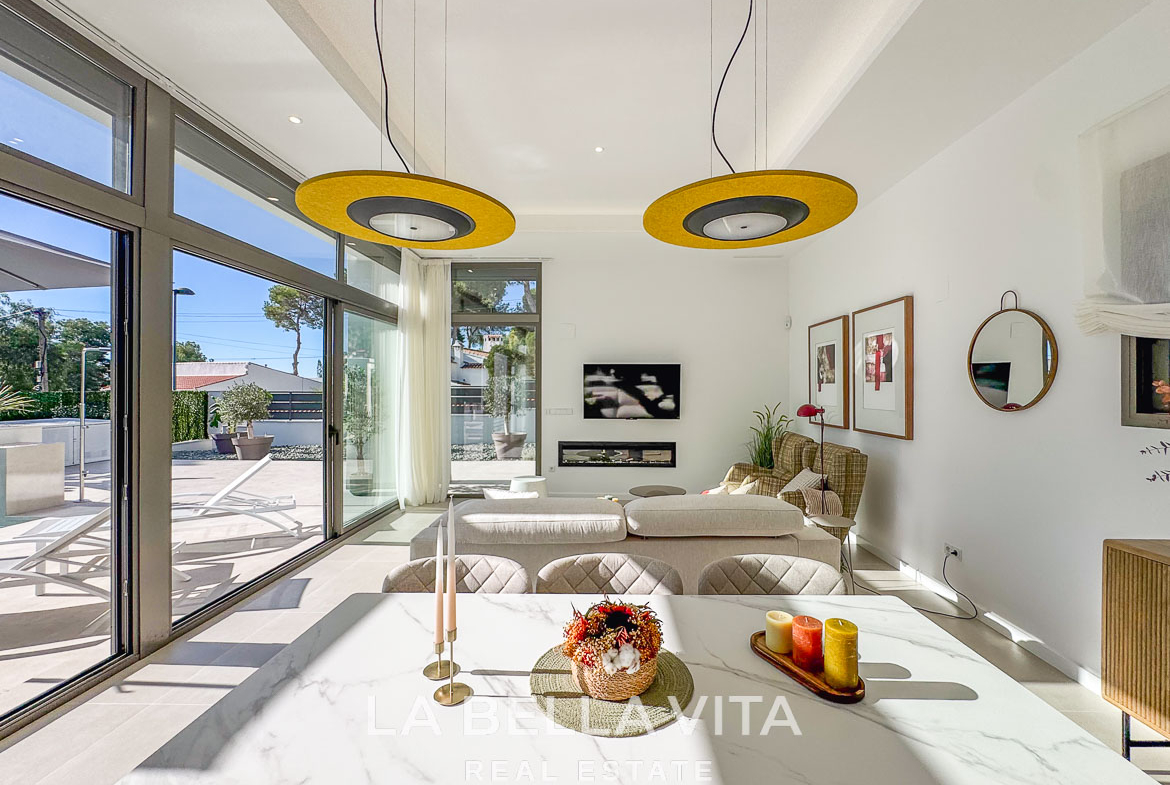Bright and spacious living room with large windows and modern decor in luxury 3-bedroom villa in Pinar de Campoverde
