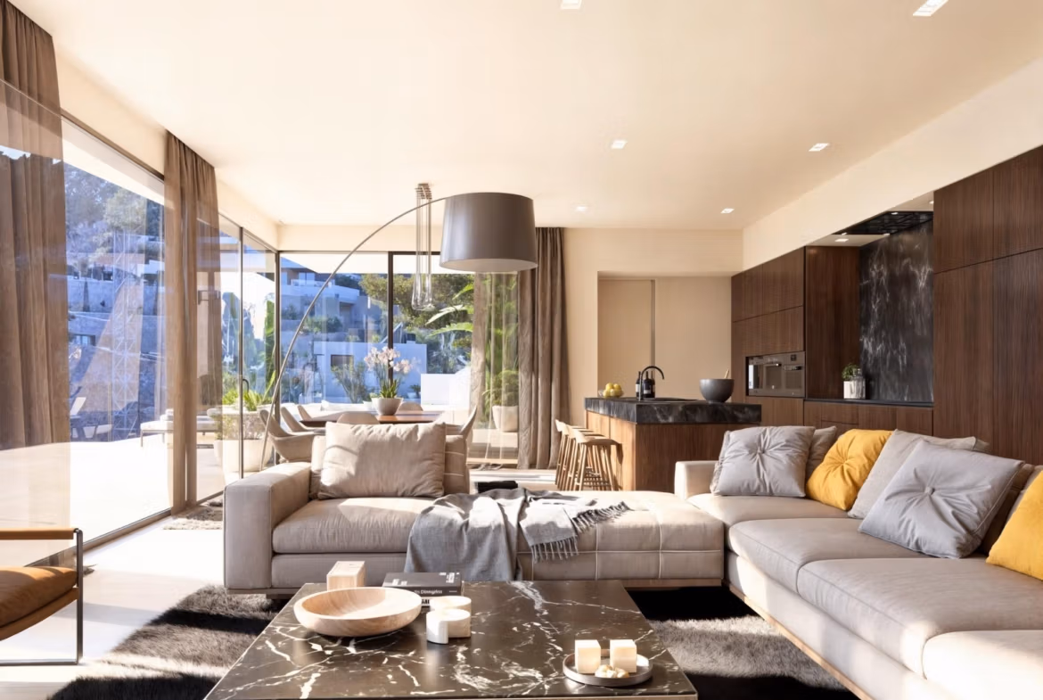 Spacious sunlit living room with modern furnishings and floor-to-ceiling windows in a luxury 4-bedroom villa in Benissa Costa.