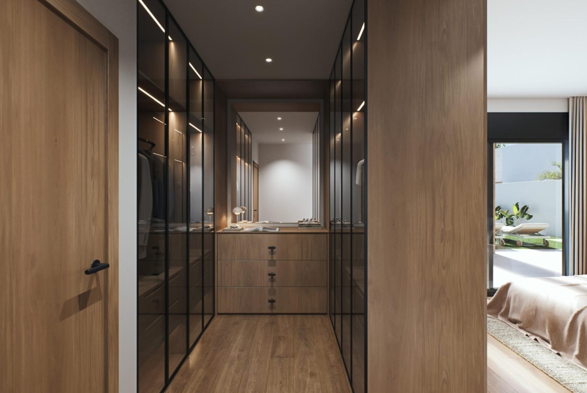 Luxury-New-Build-Villas-in-Sucina-with-Private-Pool-and-Large-Plots-11 Spacious elegant walk-in wardrobe with sleek glass wardrobes and wood finishes in luxury new build villa in Sucina, Murcia
