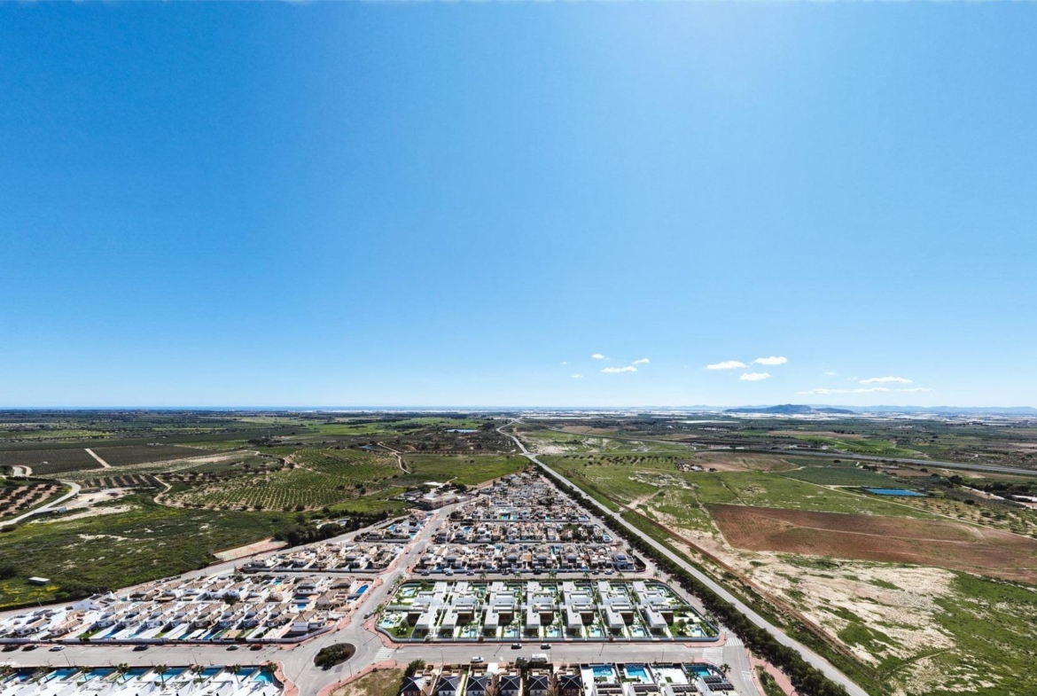 Luxury-New-Build-Villas-in-Sucina-with-Private-Pool-and-Large-Plots-2 Sun-drenched aerial view of modern luxury new build single-storey villas with private pools in Sucina, Murcia.