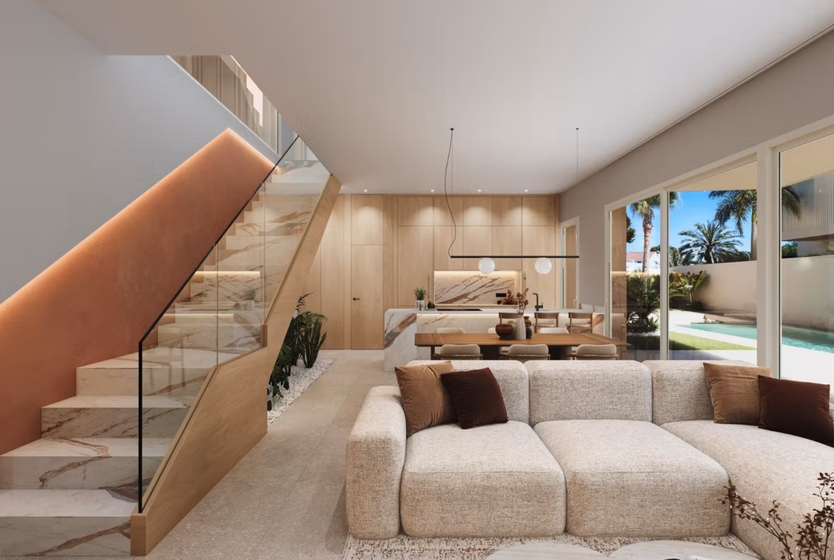 Luxury-New-Build-Villas-with-Sea-Views-in-Dehesa-de-Campoamor-Costa-Blanca-South-5 Bright, modern living room with plush sofa, open-plan kitchen, marble staircase, and garden views in Dehesa de Campoamor villa.