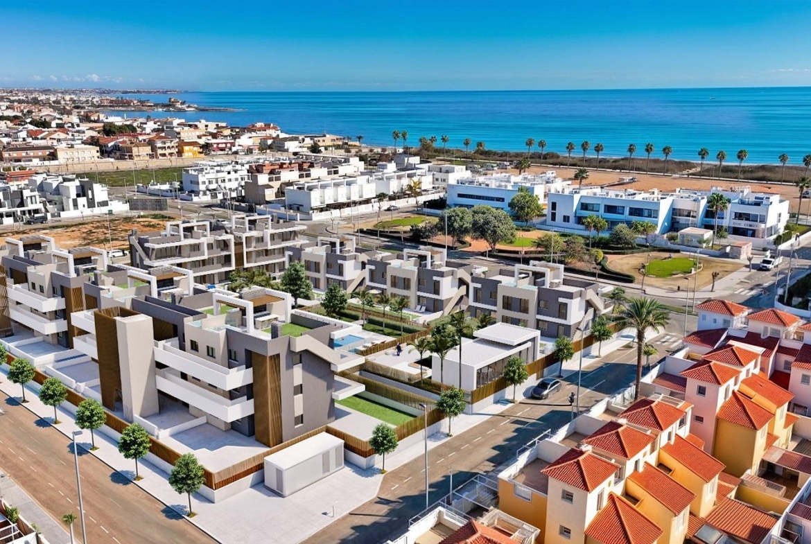 Contemporary new build 3-bedroom apartment complex with spacious terraces and lush landscaping, steps from the beach in Torre de la Horadada.