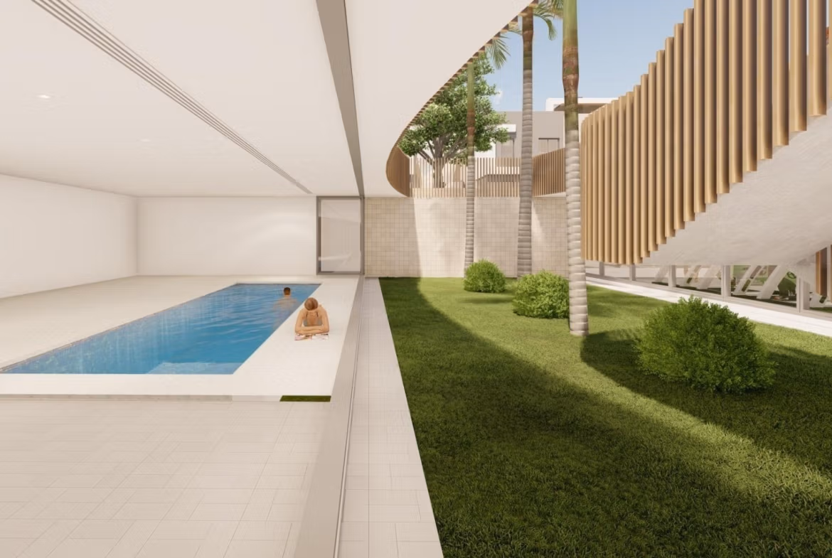 Modern luxury penthouse in Torre de la Horadada featuring a sleek indoor pool and lush landscaped terrace with natural light.