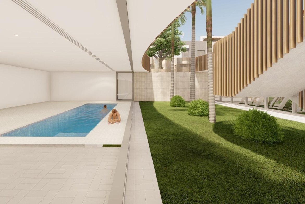 Modern luxury penthouse in Torre de la Horadada featuring a serene indoor pool and lush landscaped garden.
