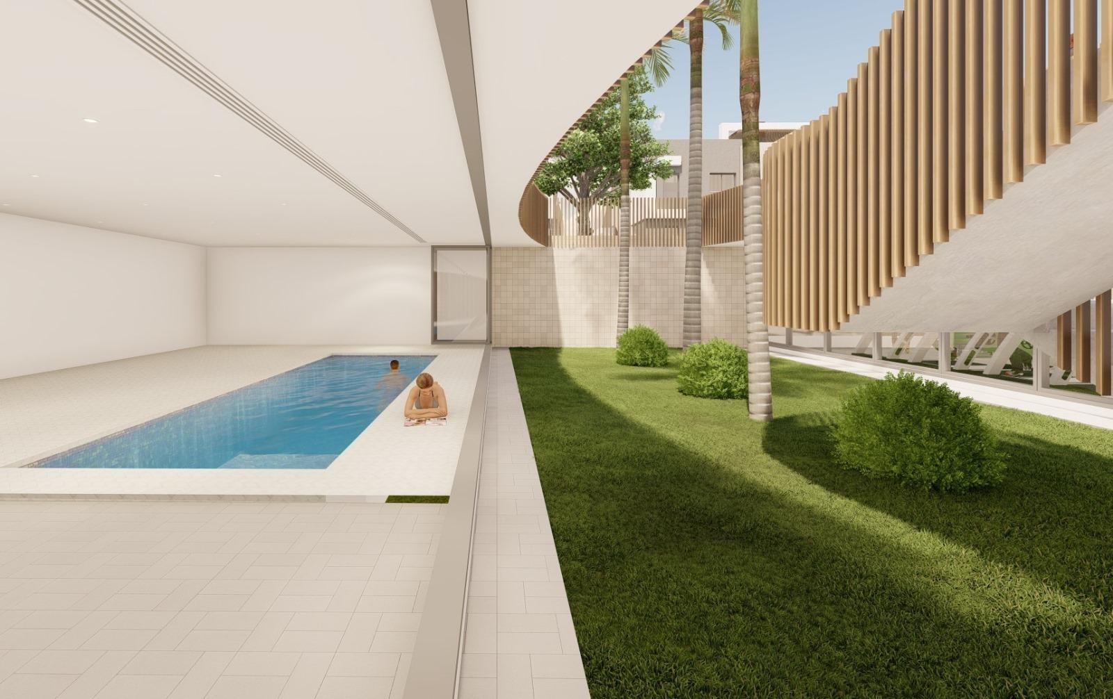 Modern luxury penthouse in Torre de la Horadada featuring a serene indoor pool and lush landscaped garden.