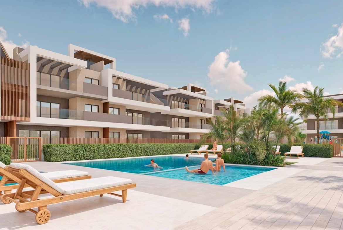 Modern Torre de la Horadada ground floor apartment complex with a pristine communal pool, sun-soaked terraces, and lush palm landscaping.