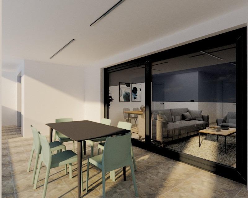 Spacious sunlit terrace with modern dining area and sleek lounge behind glass in exclusive Torre de la Horadada penthouse