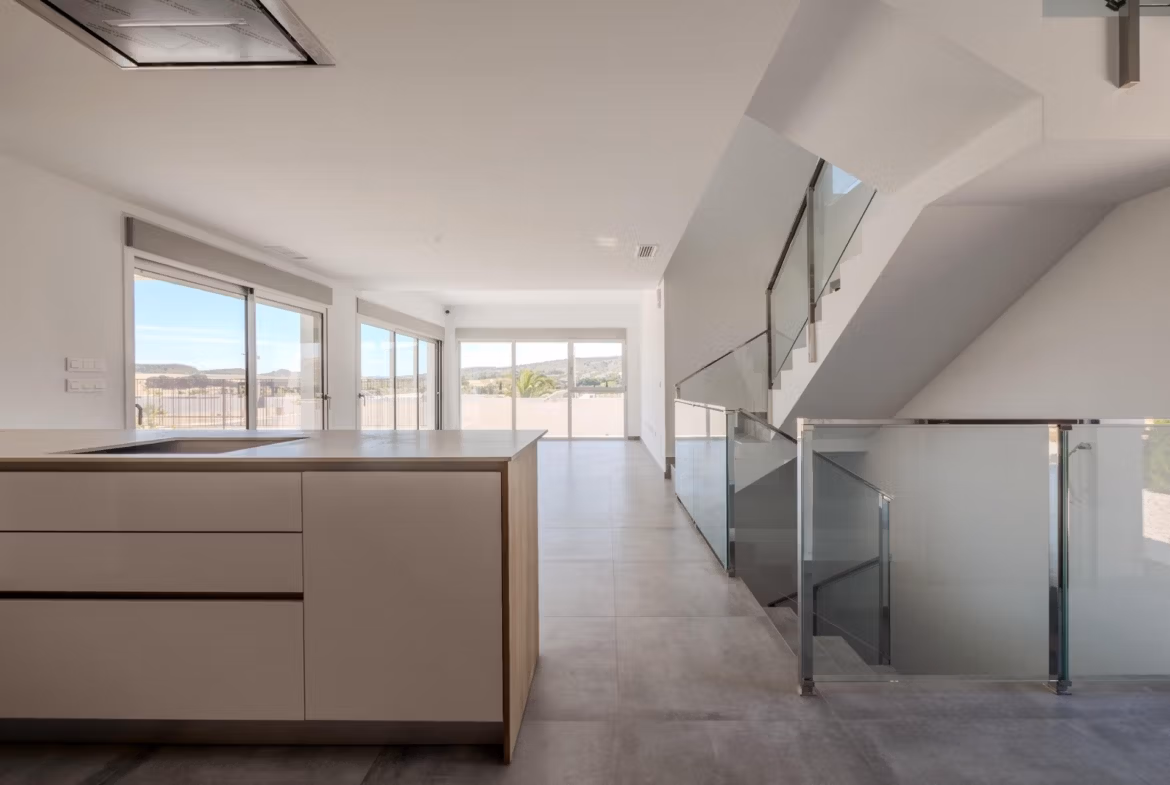 Bright modern open-plan kitchen and living area with sleek finishes and golf views in luxury 4-bedroom villa in Algorfa, La Finca.