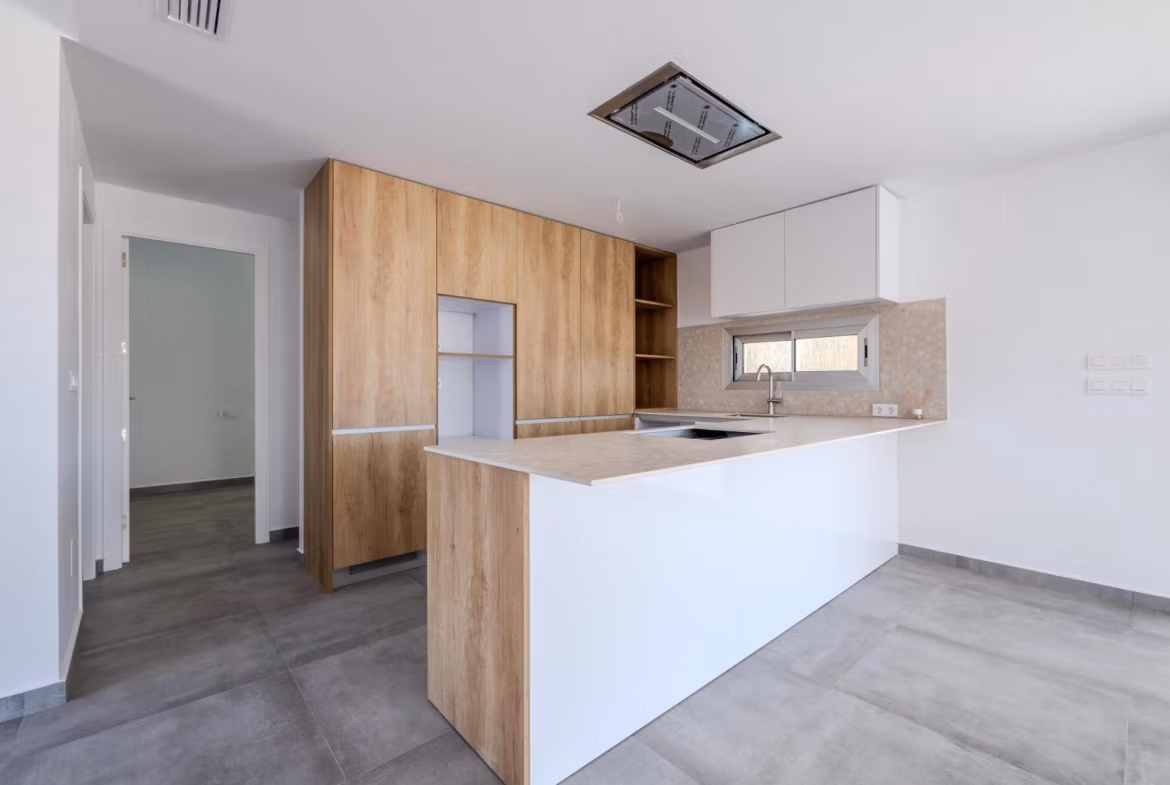 Modern, spacious kitchen with sleek wood cabinetry and bright open-plan design in a 4-bedroom villa in Algorfa, La Finca.