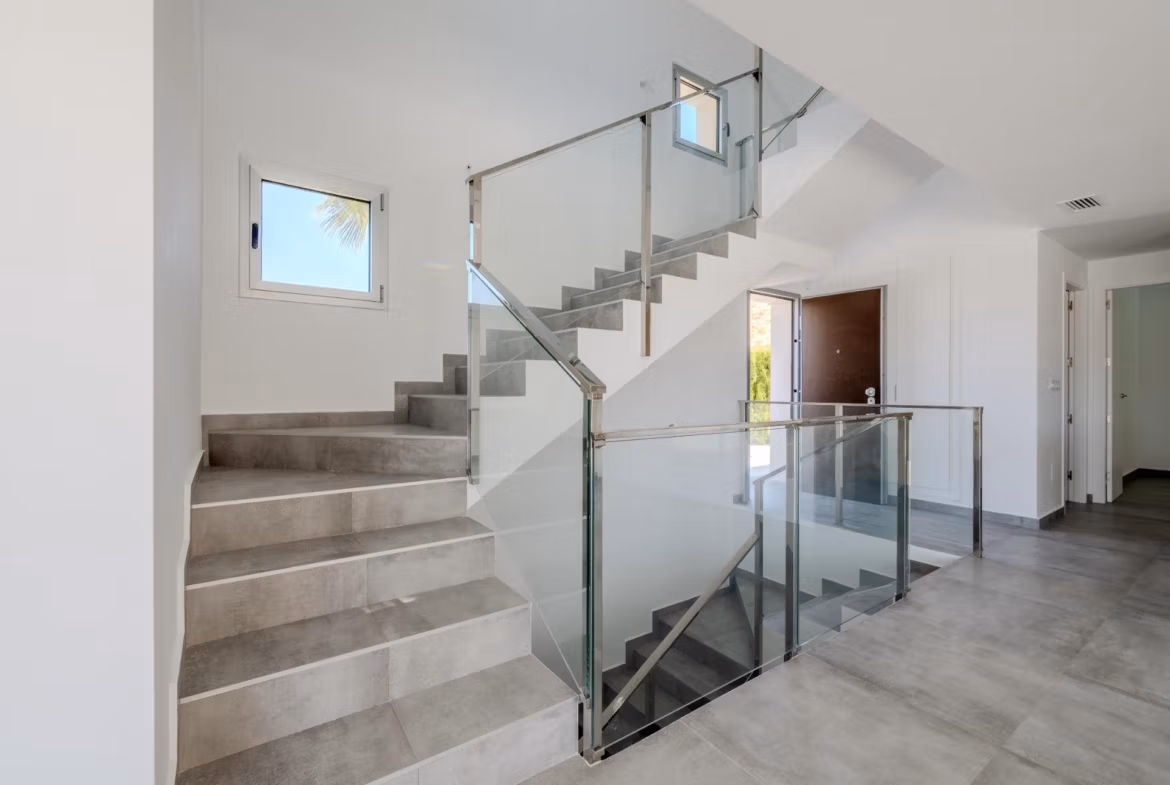 Bright modern staircase with glass balustrades in elegant 4-bedroom villa with golf views in Algorfa, La Finca.