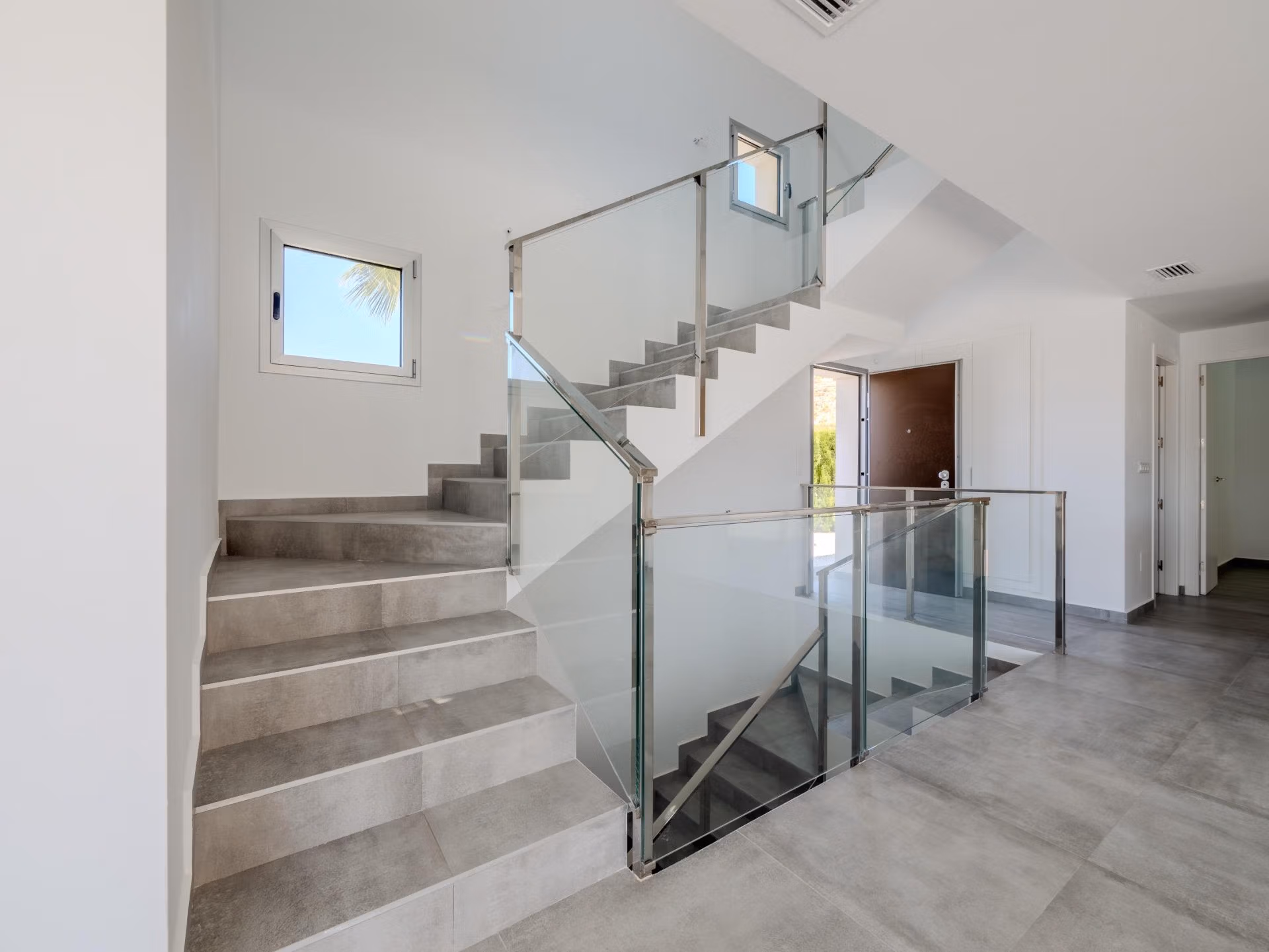 Bright modern staircase with glass balustrades in elegant 4-bedroom villa with golf views in Algorfa, La Finca.