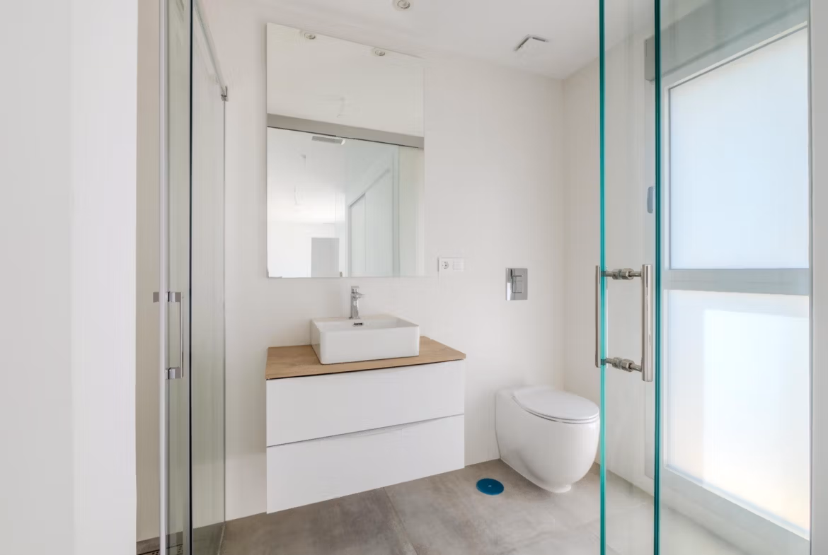 Bright, modern bathroom with sleek fixtures and frosted window in luxury 4-bedroom villa in Algorfa, La Finca.