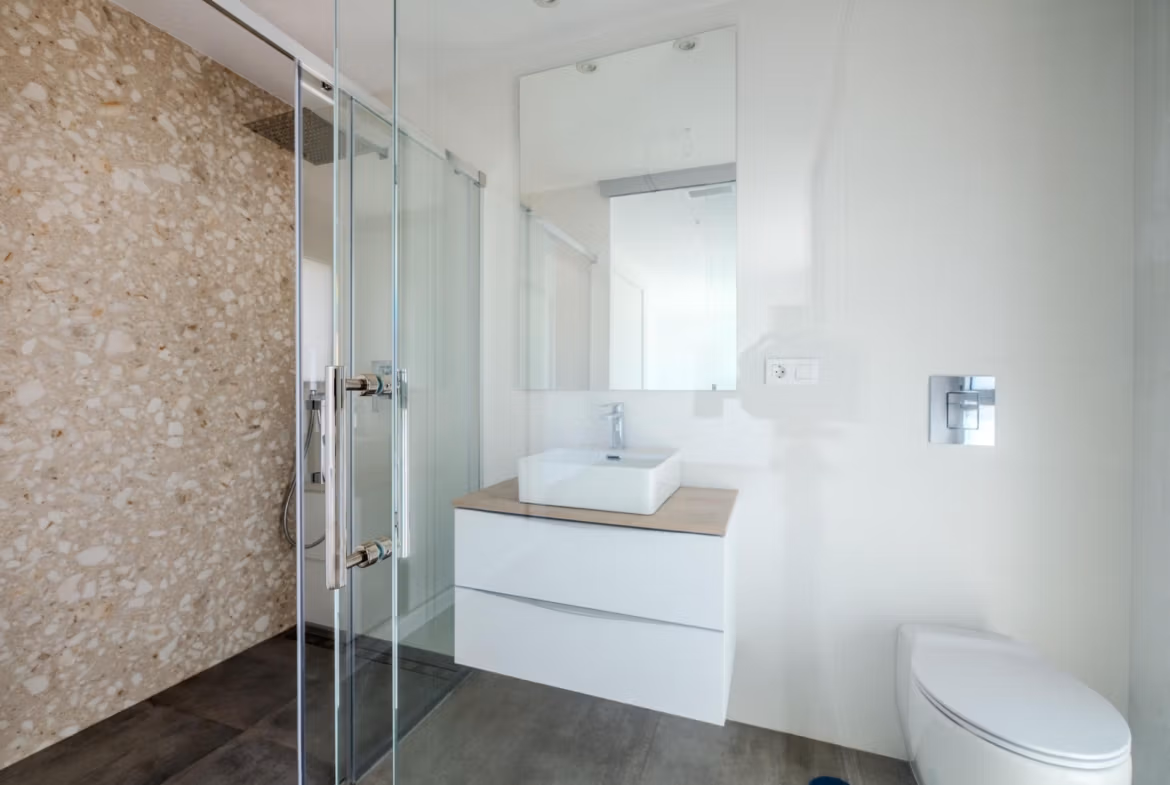 Bright modern bathroom with sleek floating vanity and walk-in shower in luxury 4 bedroom villa in Algorfa, La Finca
