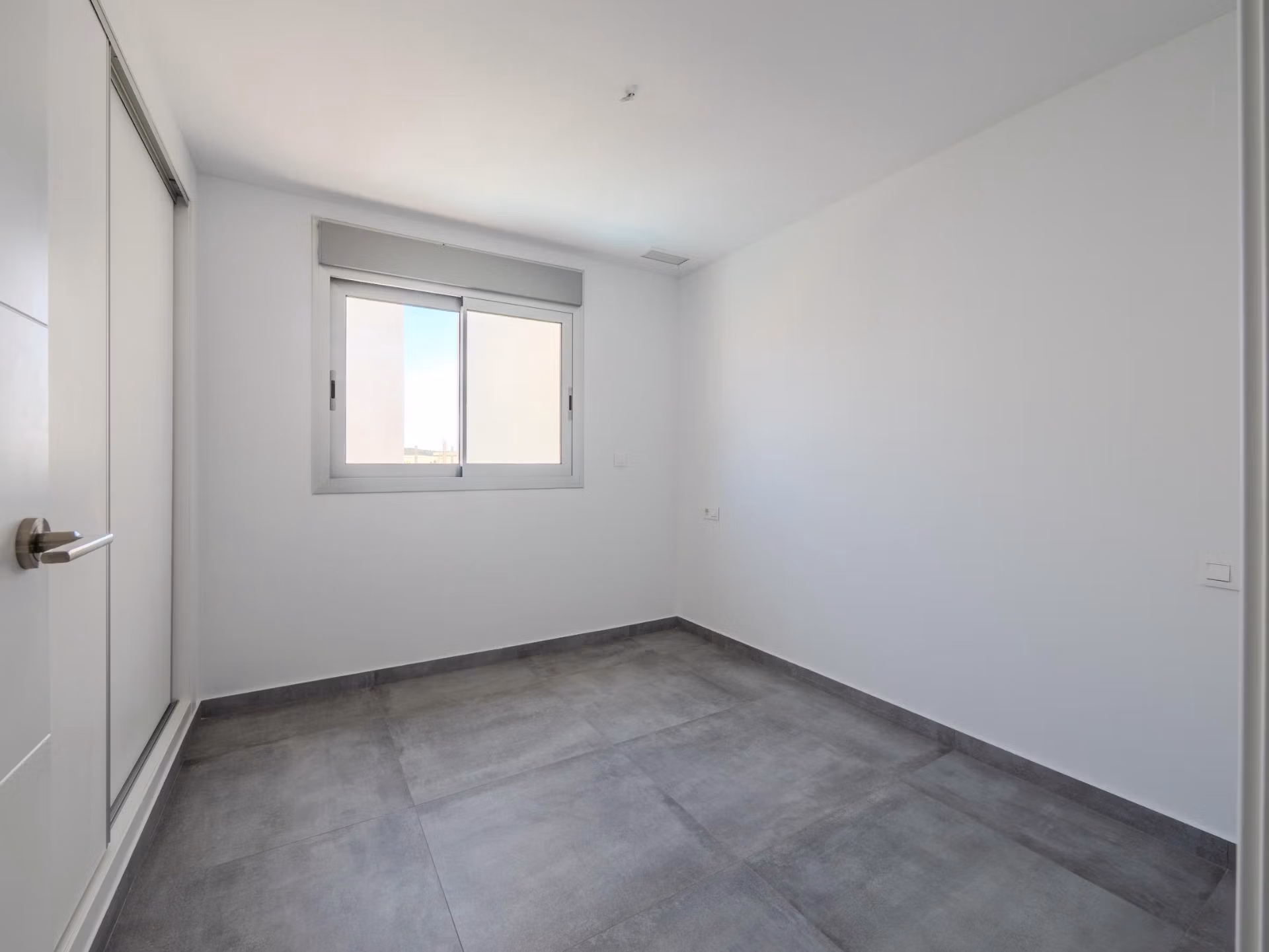 Bright minimalist bedroom with sleek tiled flooring in a contemporary 4-bedroom villa in Algorfa, La Finca