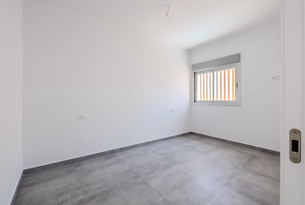Minimalist bright bedroom with sleek gray flooring in a key-ready 4-bedroom villa in Algorfa, La Finca.