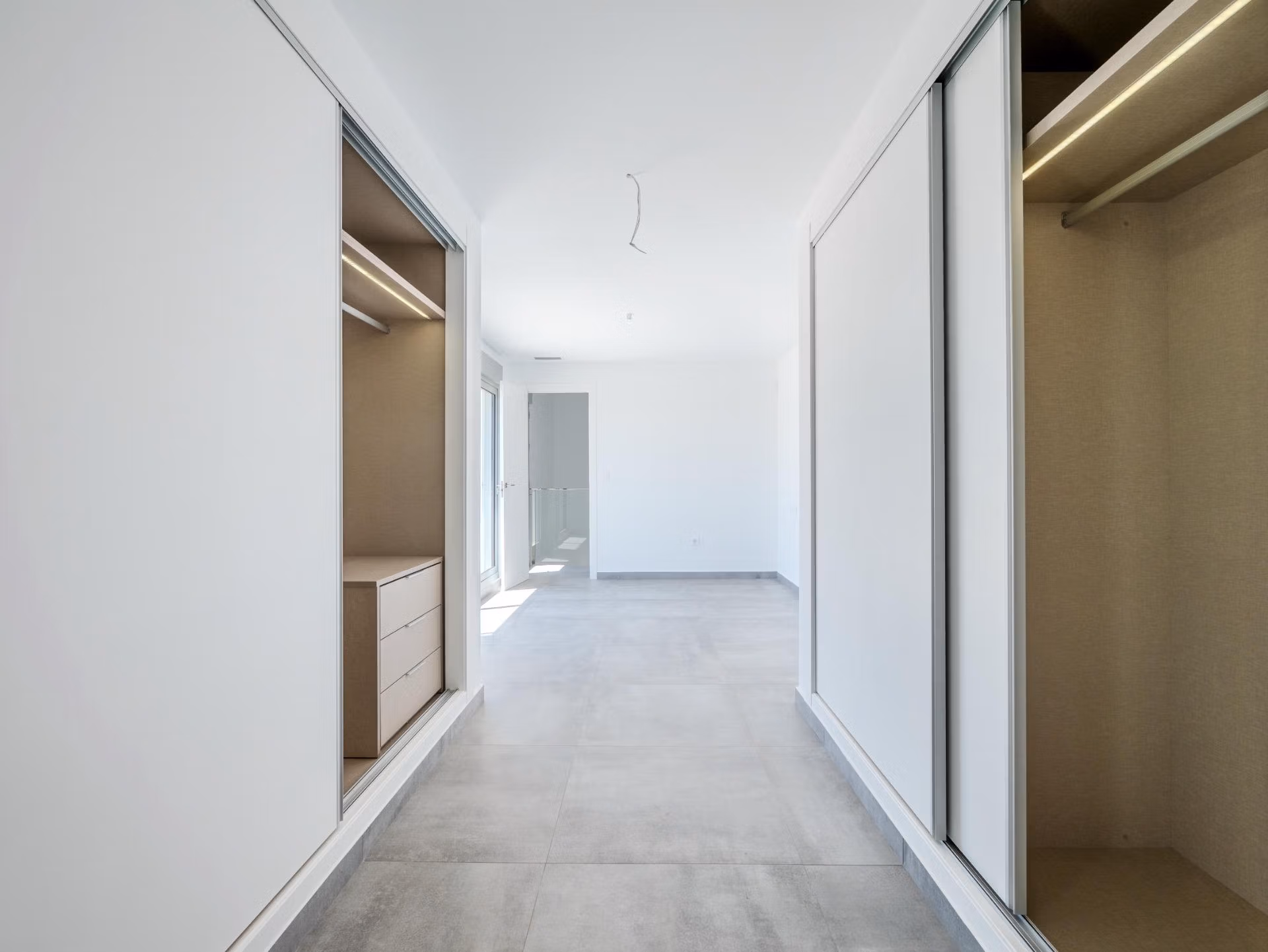 Bright, modern walk-in closet with sleek built-in wardrobes in a stunning 4-bedroom villa with golf views in Algorfa, La Finca.