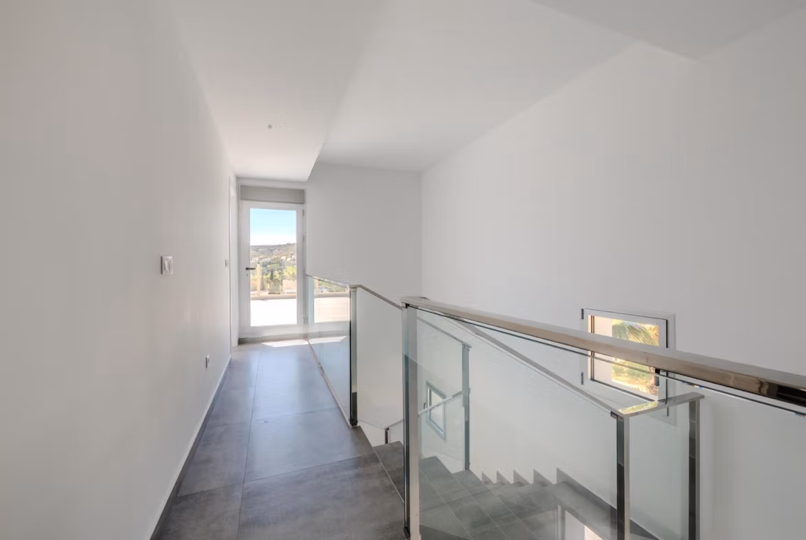 Bright modern hallway with sleek glass railing and natural light in luxury 4-bedroom villa with golf views in Algorfa, La Finca