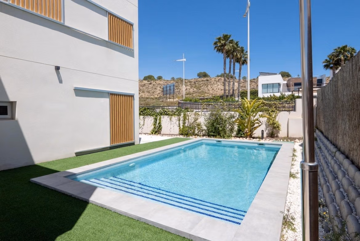 Modern 4-bedroom villa in Algorfa with a pristine private pool, sleek outdoor shower, and sun-drenched terrace overlooking golf views.