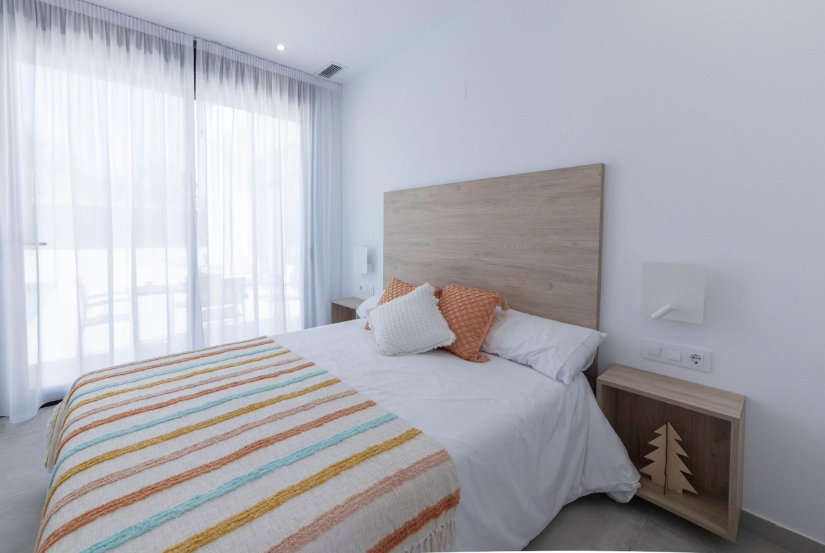 Bright modern bedroom with floor-to-ceiling windows in a new 3-bedroom villa in Calasparra, Murcia.