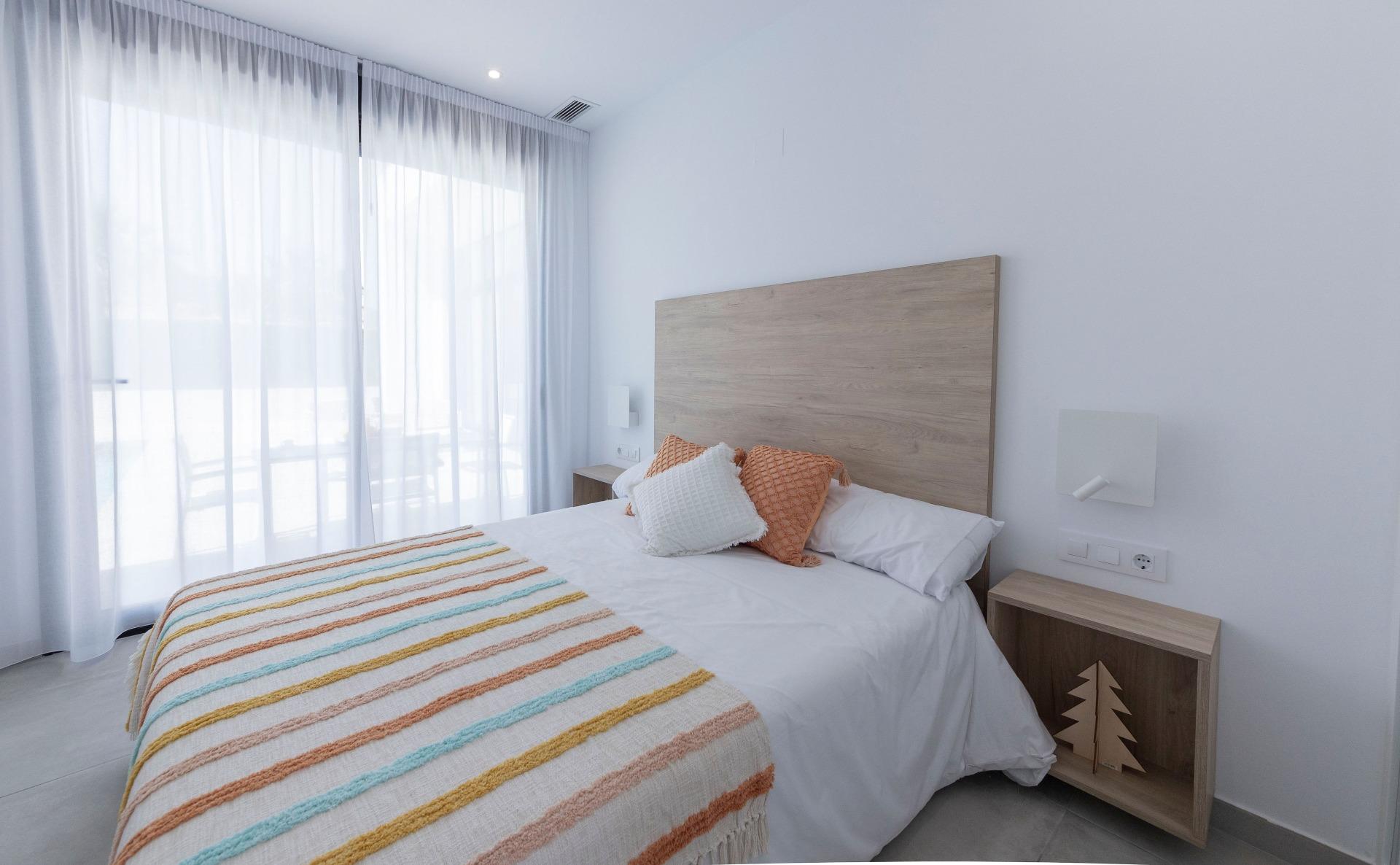 Bright modern bedroom with floor-to-ceiling windows in a new 3-bedroom villa in Calasparra, Murcia.