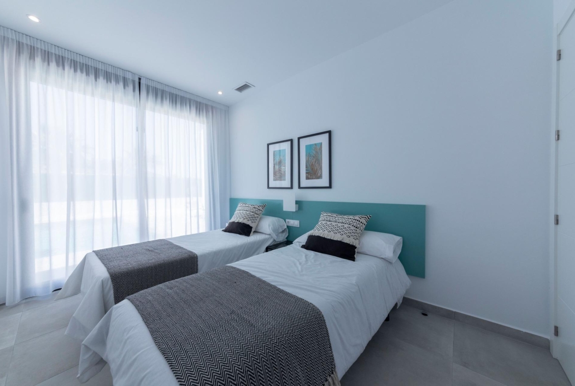 Bright modern twin bedroom with sheer curtains in a sleek 3-bedroom villa in Calasparra, Murcia