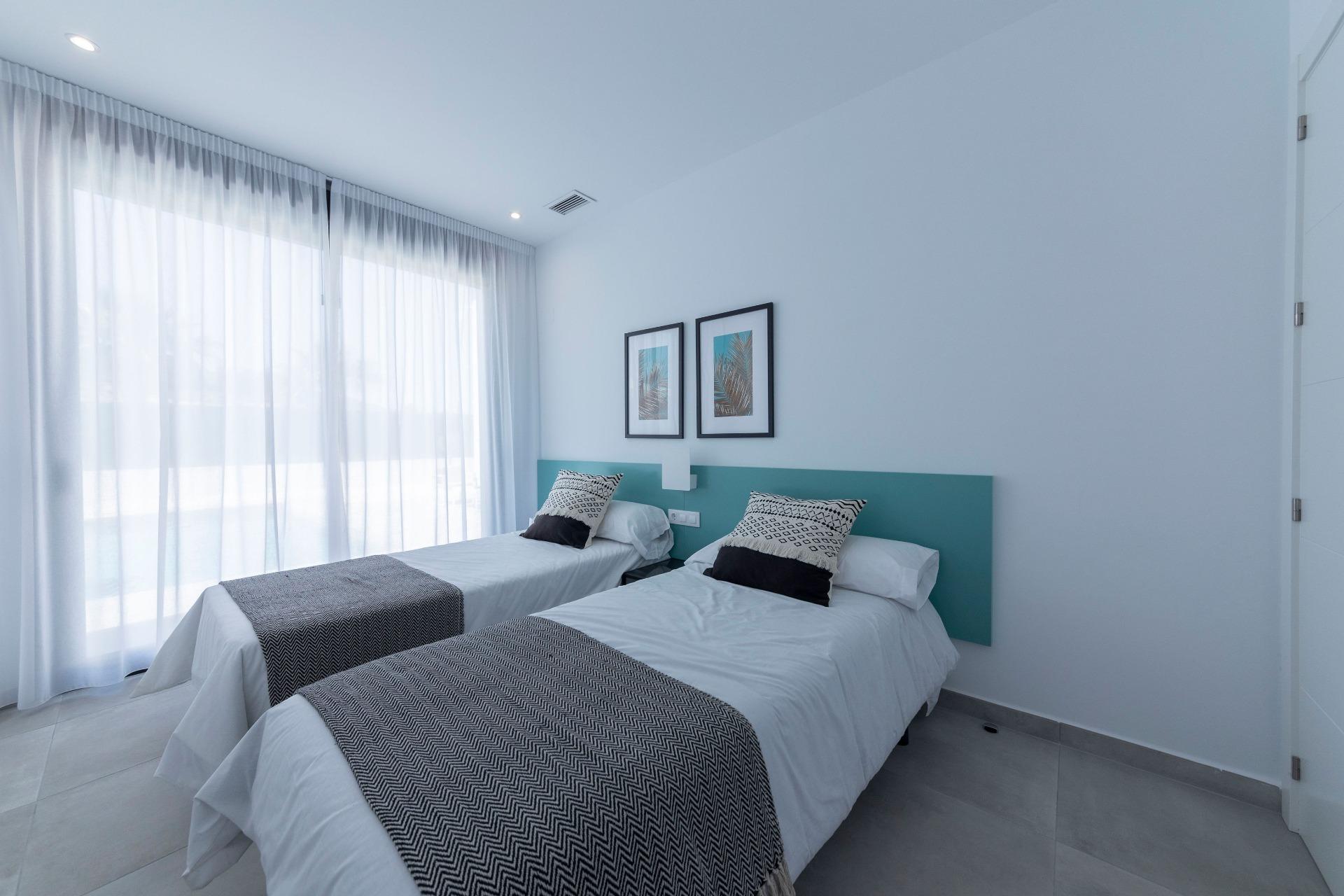 Bright modern twin bedroom with sheer curtains in a sleek 3-bedroom villa in Calasparra, Murcia