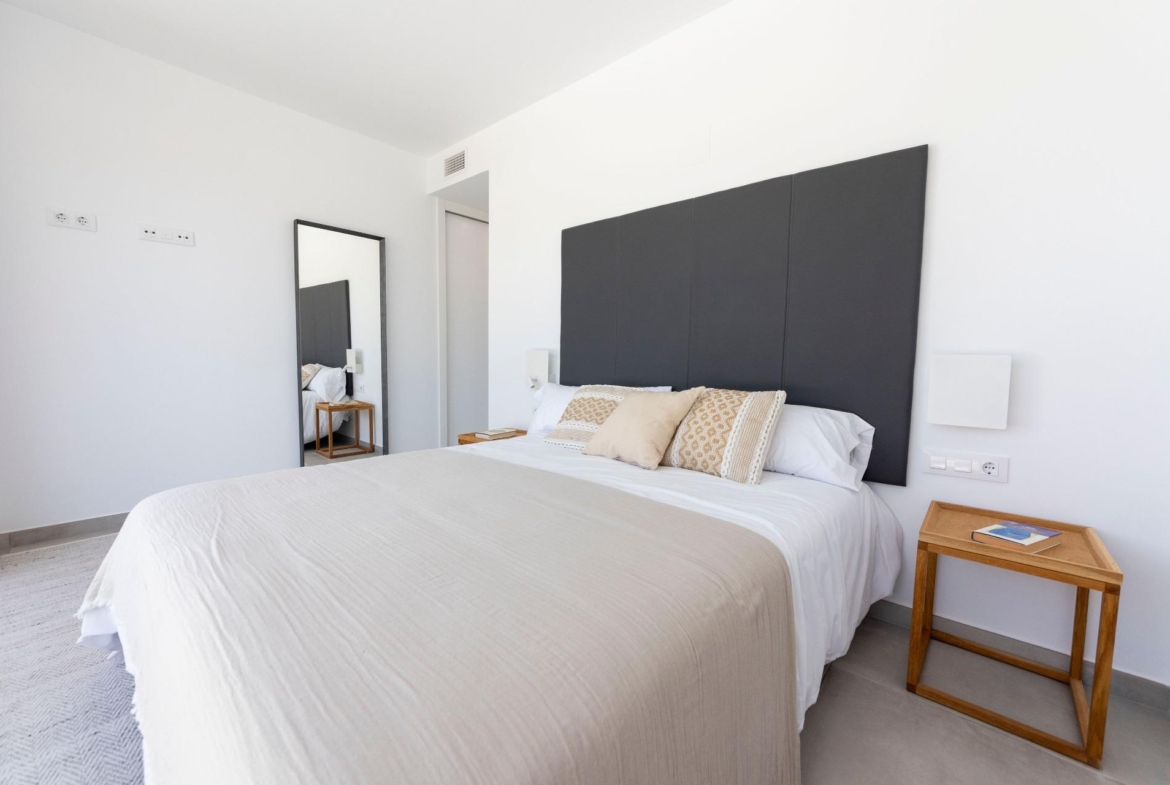 Bright modern bedroom in a sleek 3-bedroom villa in Calasparra, featuring minimalist decor and soft, neutral tones.
