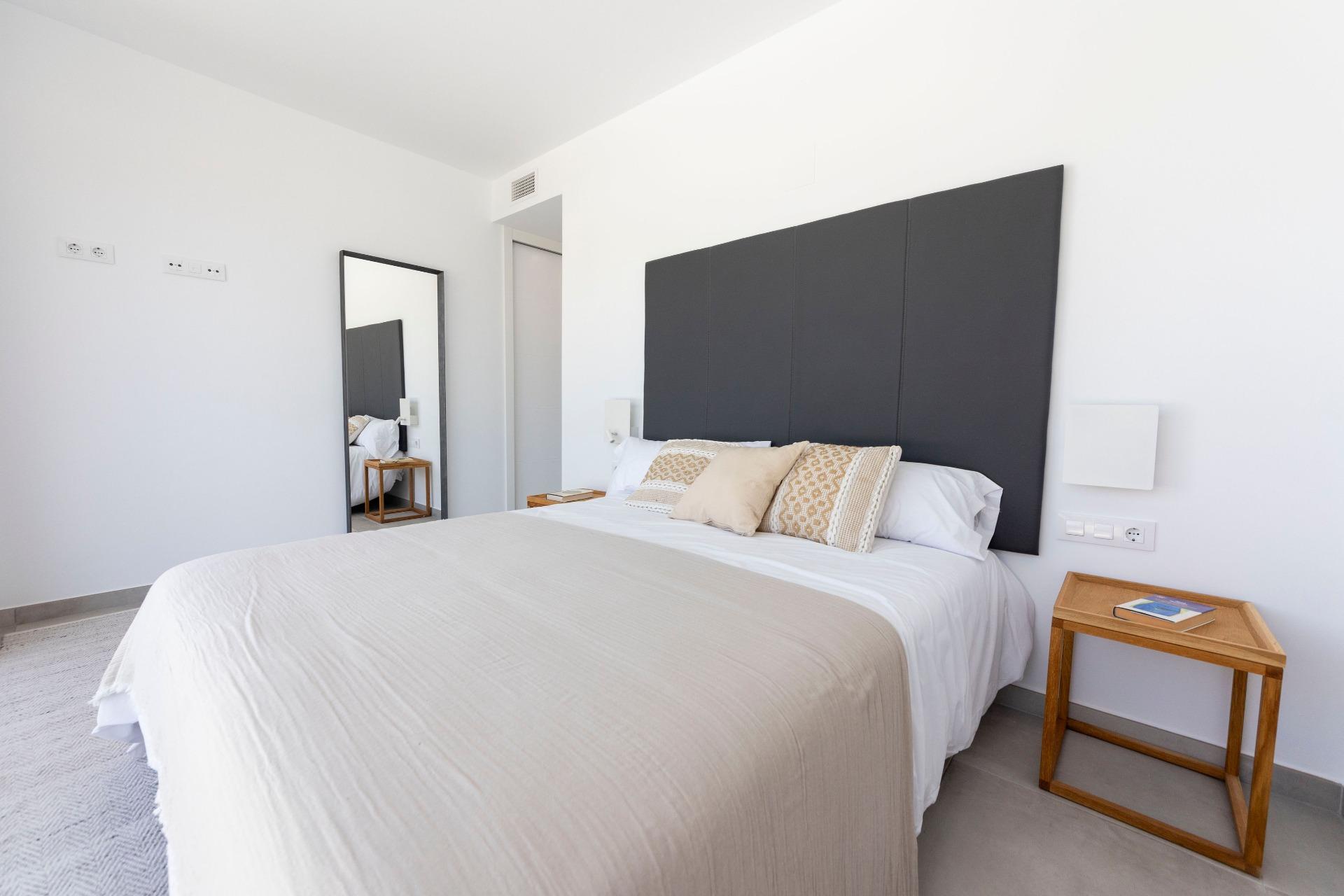 Bright modern bedroom in a sleek 3-bedroom villa in Calasparra, featuring minimalist decor and soft, neutral tones.