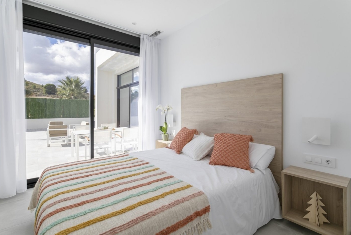 Bright modern bedroom with sliding glass doors opening to sun-drenched terrace in spacious 3-bedroom villa, Calasparra Murcia