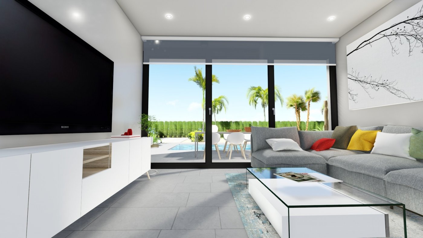 Bright modern living room with sleek furniture and glass doors opening to private pool at charming 2-bedroom villa in Calasparra, Murcia