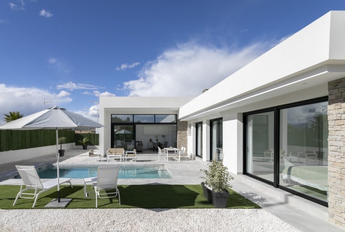 Modern, sun-drenched 3-bedroom villa exterior in Calasparra with a private pool and spacious terrace under a bright blue sky.