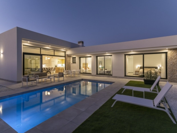 Modern spacious 3-bedroom villa in Calasparra, Murcia with illuminated private pool and elegant outdoor terrace at dusk.
