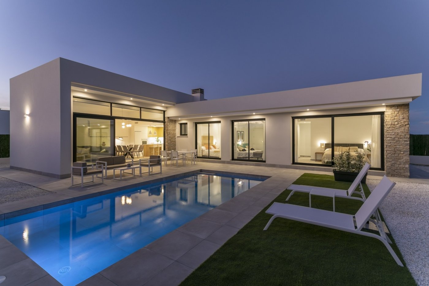 Elegant spacious new build 3-bedroom villa with private pool and terrace illuminated at dusk in Calasparra, Murcia.