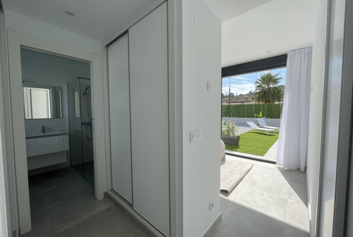 Bright modern hallway with built-in storage leading to sunlit terrace and private pool in spacious 3-bedroom villa in Calasparra, Murcia