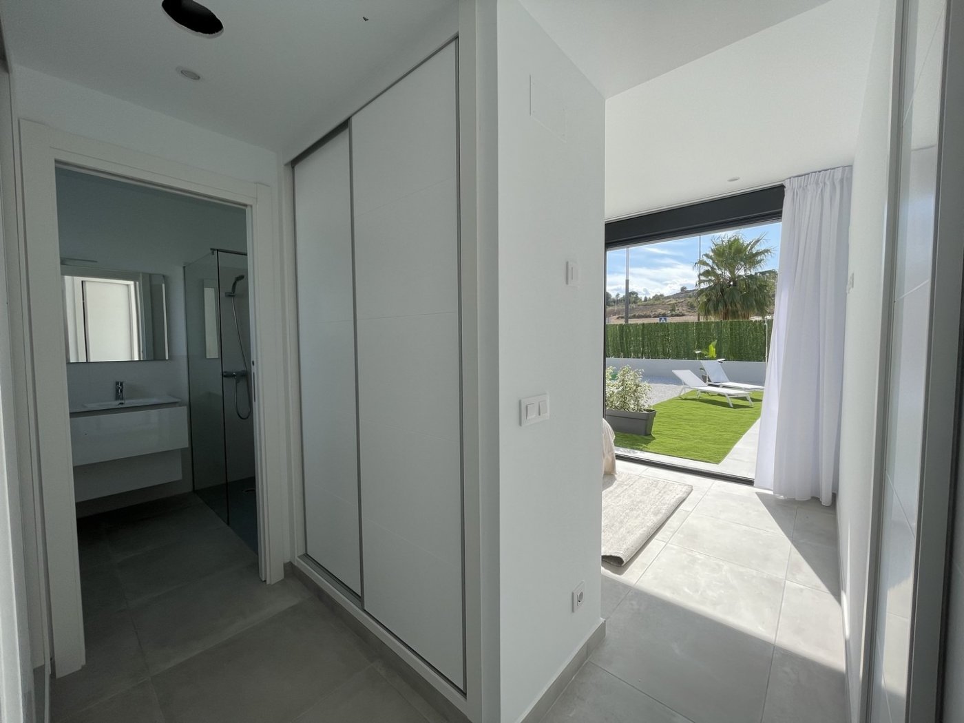 Bright modern hallway with built-in storage leading to sunlit terrace and private pool in spacious 3-bedroom villa in Calasparra, Murcia