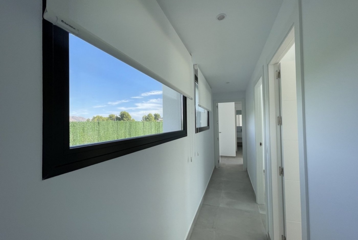 Bright, minimalist hallway with large windows showcasing serene views in a spacious new build 3-bedroom villa in Calasparra, Murcia