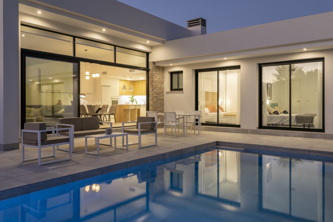 Modern spacious 3-bedroom villa in Calasparra, Murcia, featuring a private illuminated pool and sleek open terrace at dusk.