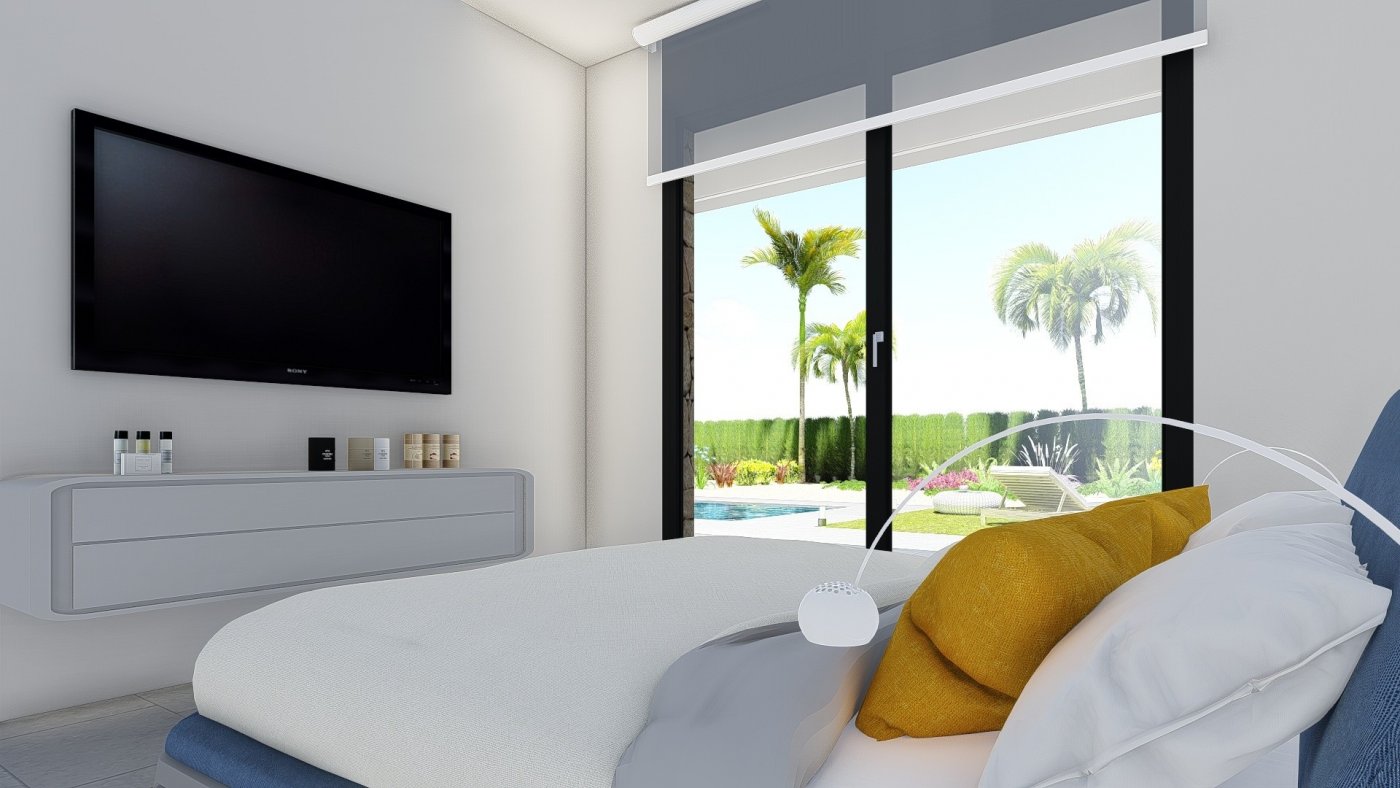 Bright modern bedroom with large glass doors opening to a landscaped garden and private pool in a New Build 2 Bedroom Villa, Calasparra.