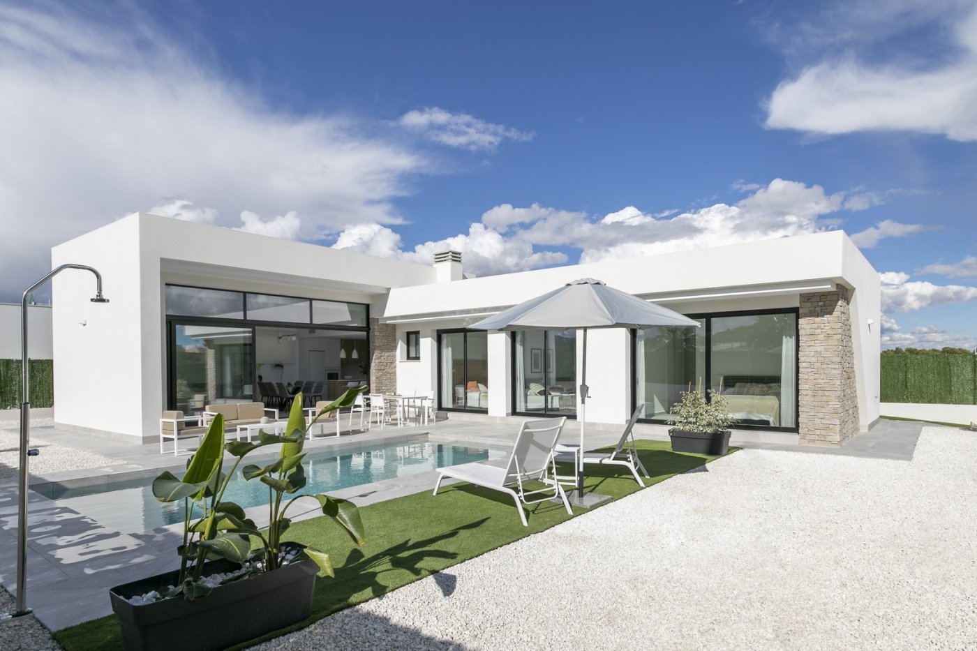 Modern spacious 3 bedroom villa in Calasparra with private pool, sun-drenched terrace, and sleek white exterior under blue sky.